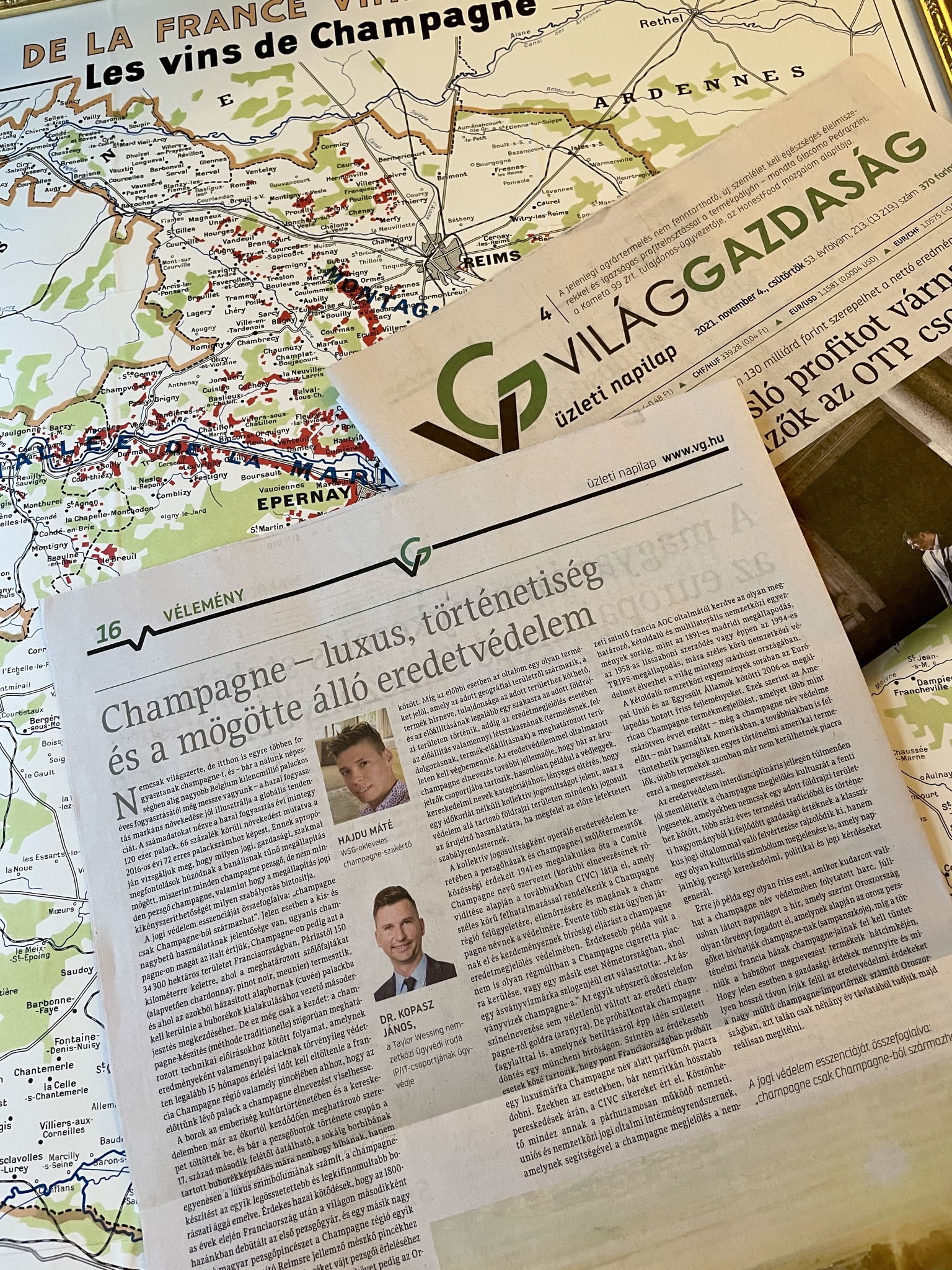 The full Világgazdaság Champagne article by Máté Hajdu and János Kopasz, photographed on a map of the Champagne region
