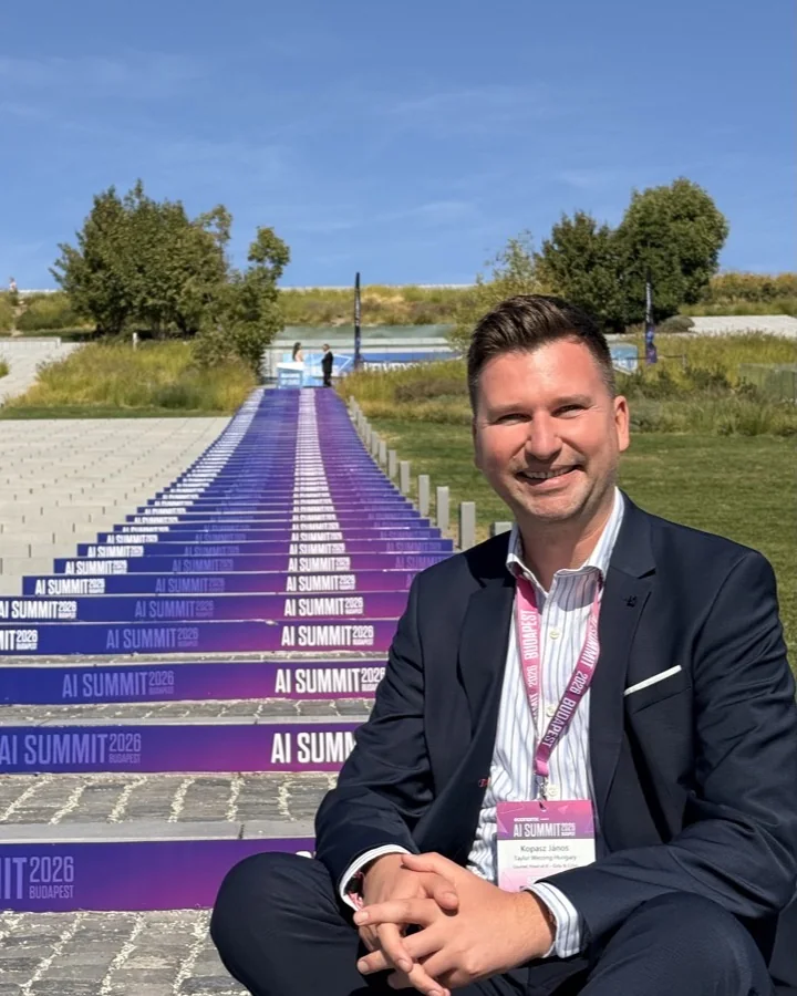 Dr. János Kopasz seated on the AI Summit Budapest 2026 steps in City Park, Budapest, after the talk